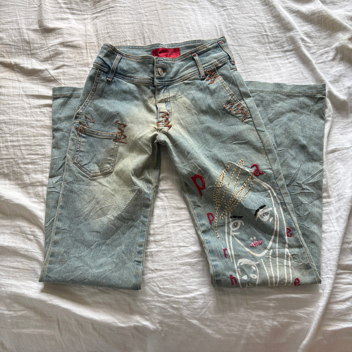 00s avant garde abstract face jeans (size S)